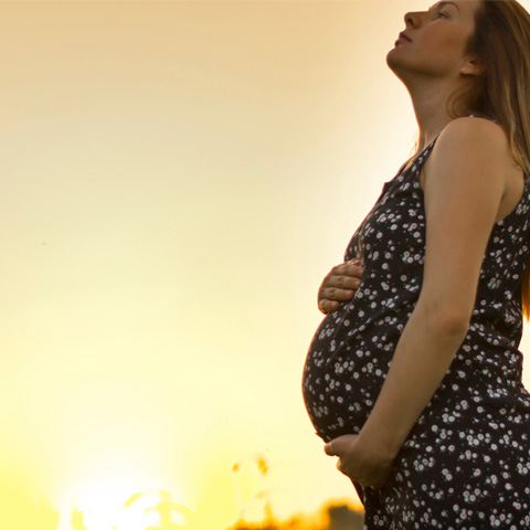 Pregnant woman looking at the sky