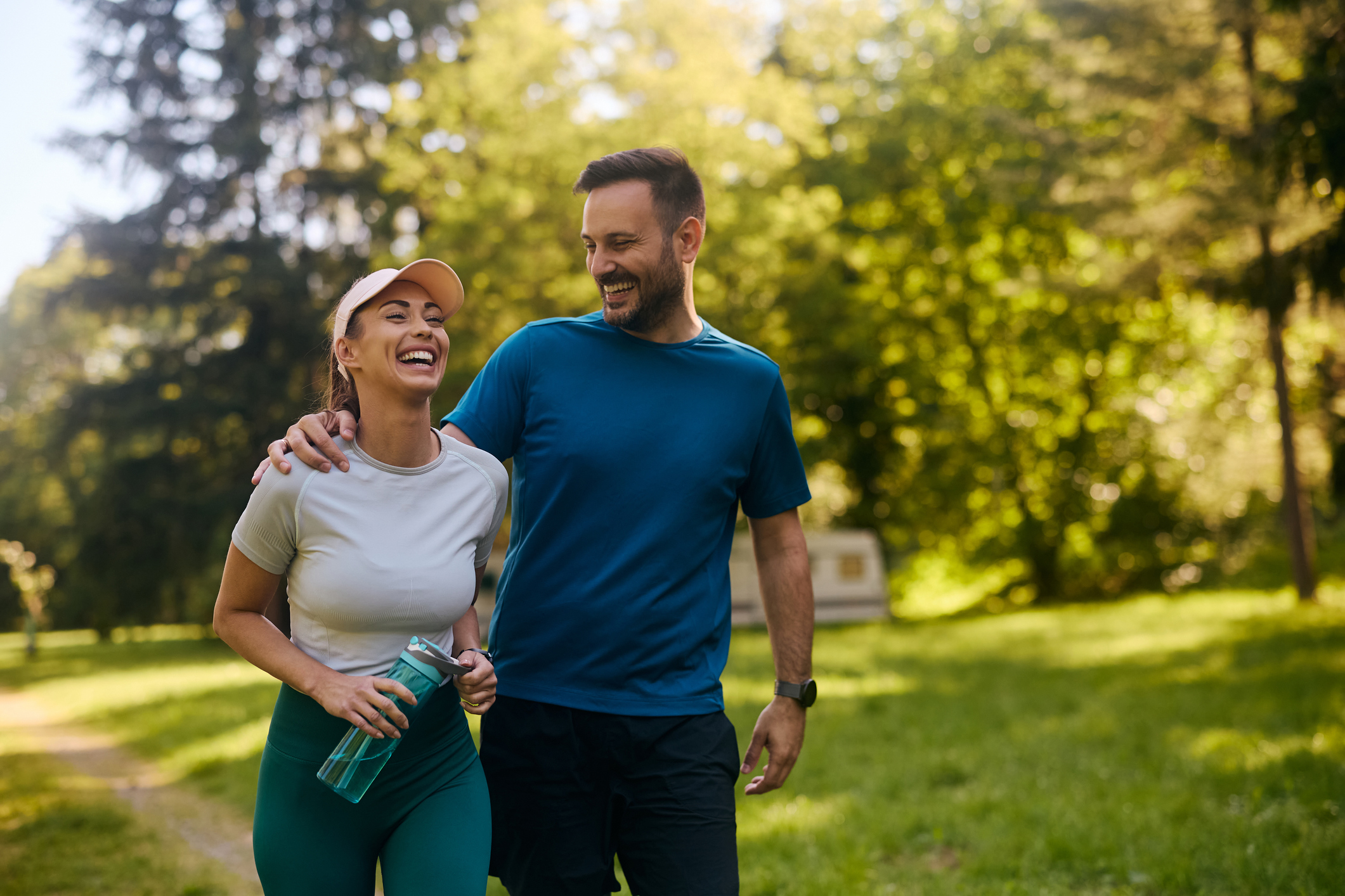 Happy couple laughing while working out in the park. Navigating the Stages from Perimenopause to Menopause